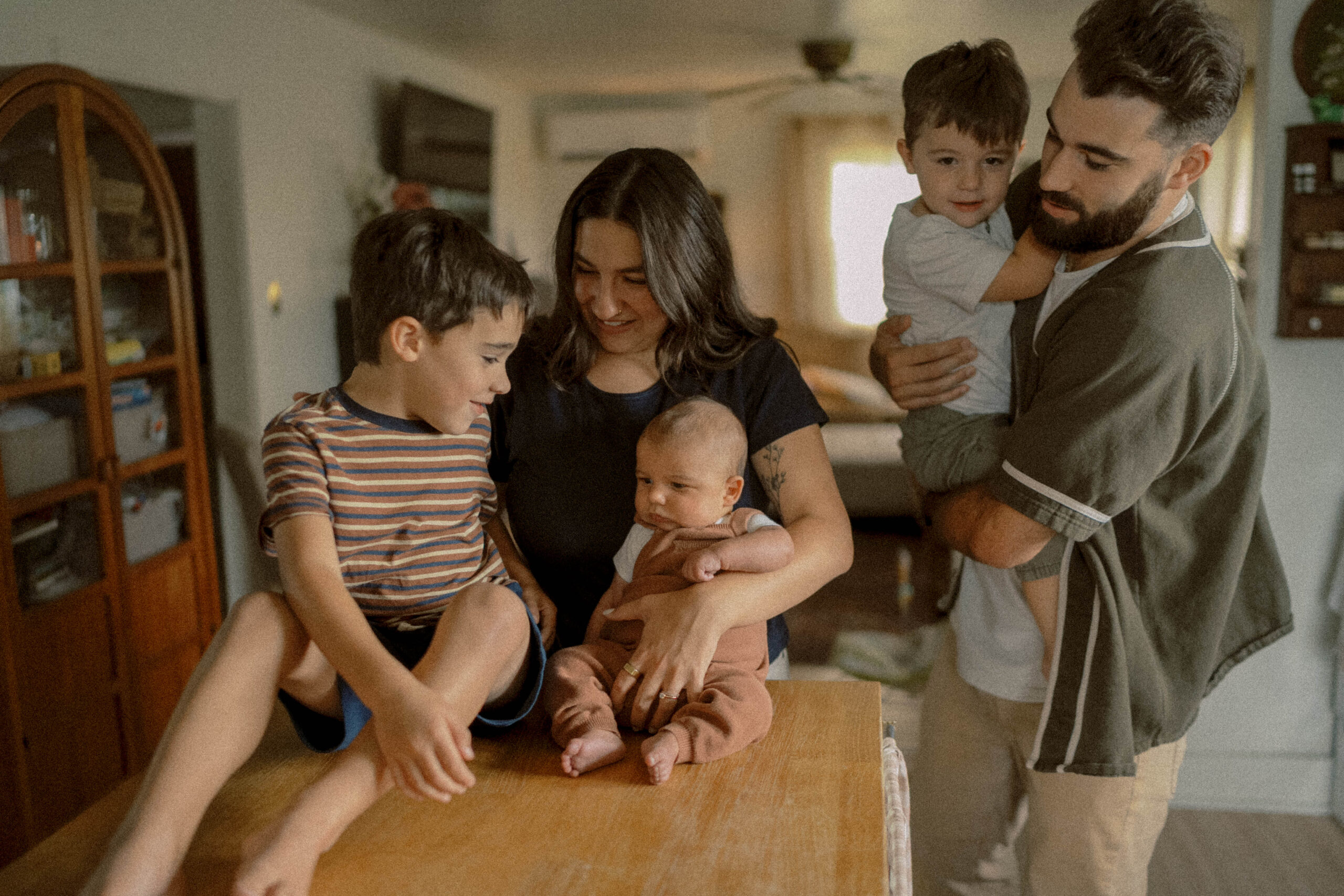 family cuddles in their kitchen during their mechanicsburg photo session