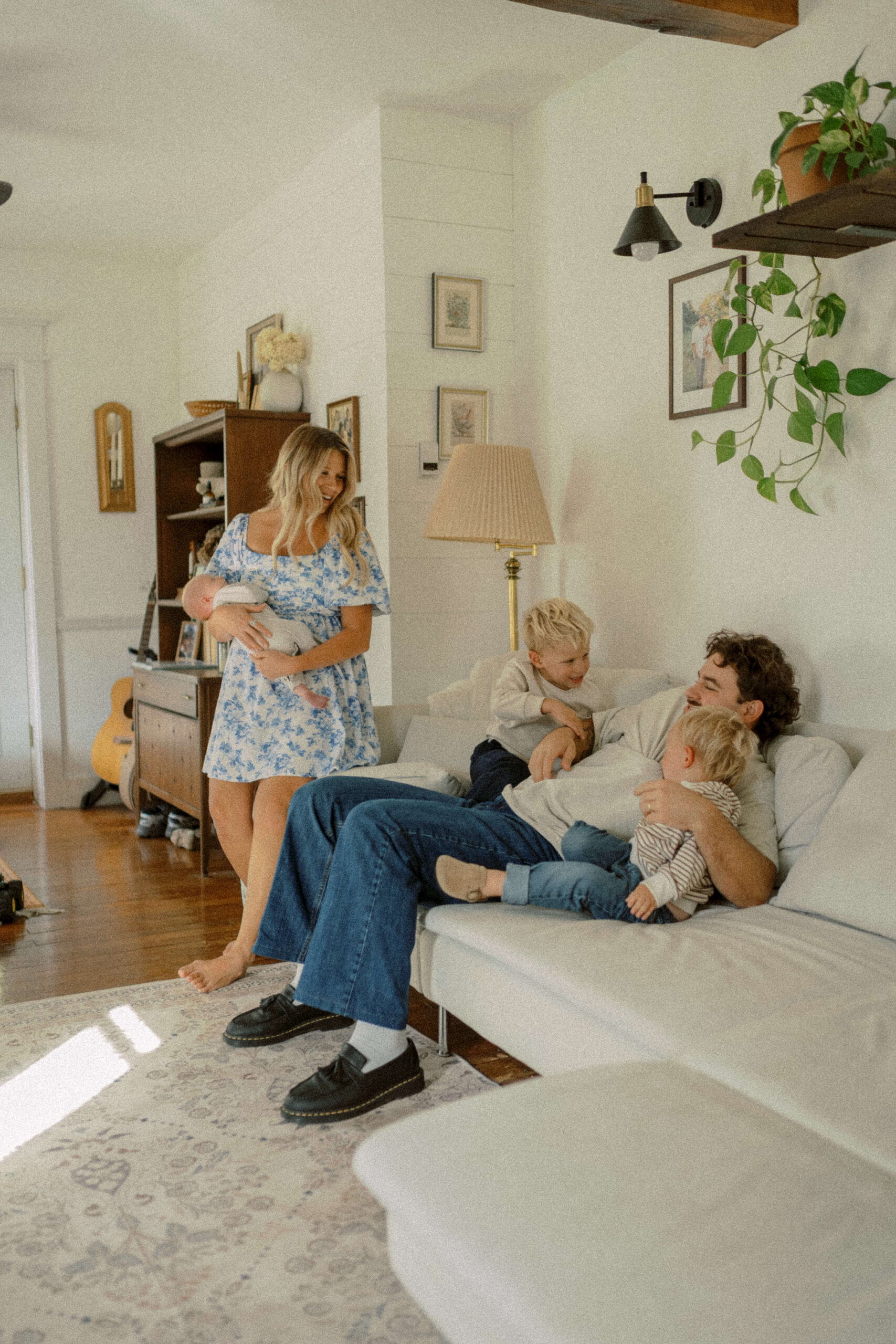 Family sits on their couch in their living room during their Fall family photos with Philadelphia Family Photographer - Jessica Mae